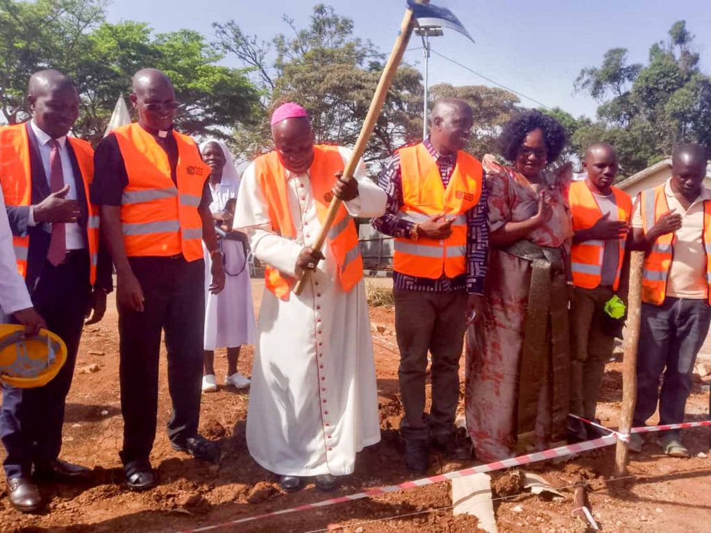 Bishop Jjumba breaking ground to officially commence the construction works at Kitovu Hospital