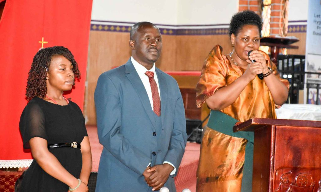 Centenary bank staff delivering a speech in Kitovu Cathedral 